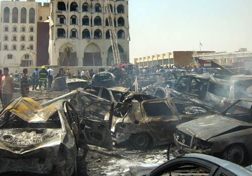 <span class="lh16 fa fs12 fb"><strong>Scene of devastation:</strong> Burnt cars are seen in front of the damaged Iraqi foreign ministry building following a massive explosion. One of the truck bombs exploded outside the foreign ministry in a residential area close to the Green Zone sending plumes of smoke and dust into the air, leaving a crater three metres (10 feet) deep and 10 metres in diameter filled with the twisted wreckage of dozens of cars and several charred corpses.(AFP)</span>