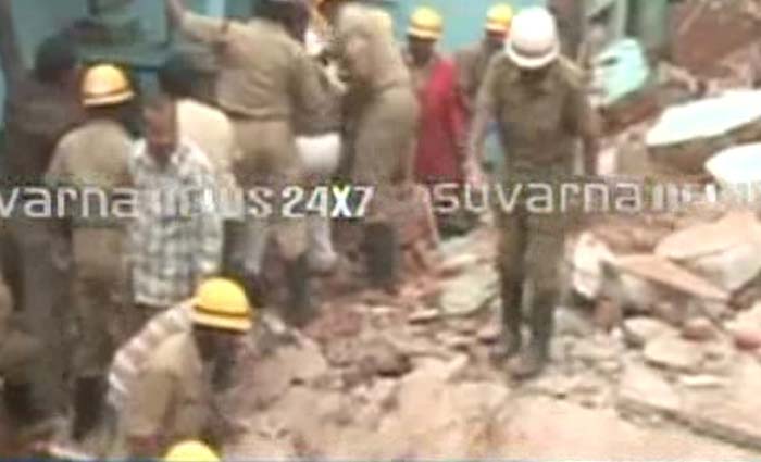 A part of a building used as a marriage hall in Bangalore collapsed this afternoon after a cylinder exploded in a house next door.