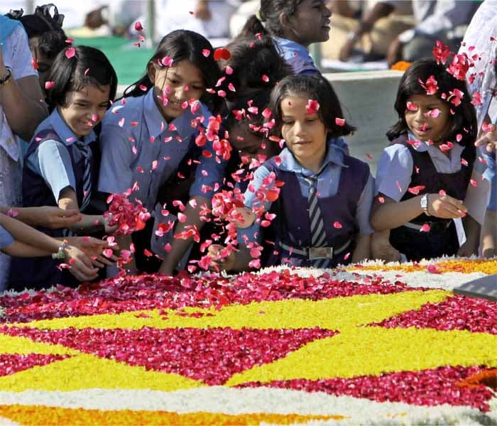 <strong>Flowers for Bapu:</strong> Schoolchildren pay floral tribute to Mahatma Gandhi on his 140th Birth Anniversary at Gandhi Memorial in New Delhi. <em>(PTI)</em>