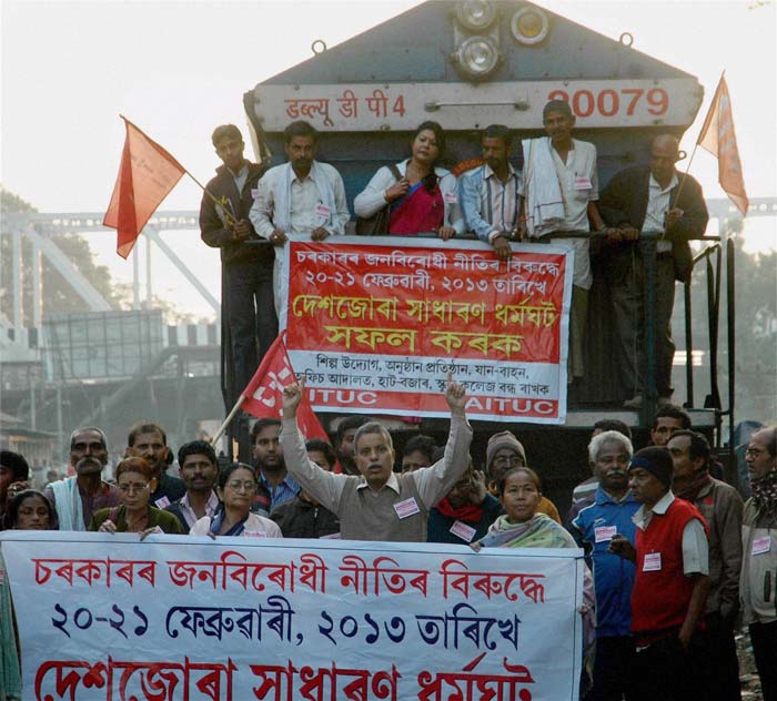 Protesters block a train during the two day nation-wide strike called by several central trade unions in Guwahati.