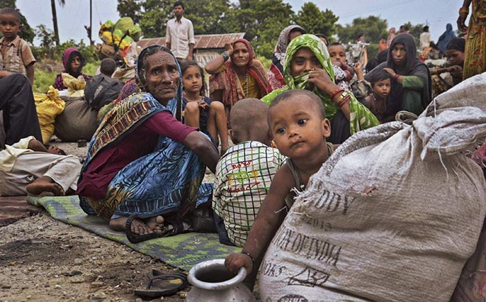 Villagers who left their homes along the Kosi River looking for safer places rest at a way side relief camp at Birpur Bihar on Sunday. A massive landslide in northern Nepal, early Saturday blocked a mountain river, causing the water to form a lake that was threatening to burst and sweep several villages. Because of the risk of flash floods coming from Nepal, thousands of villagers have been evacuated in neighboring Indias Bihar state.