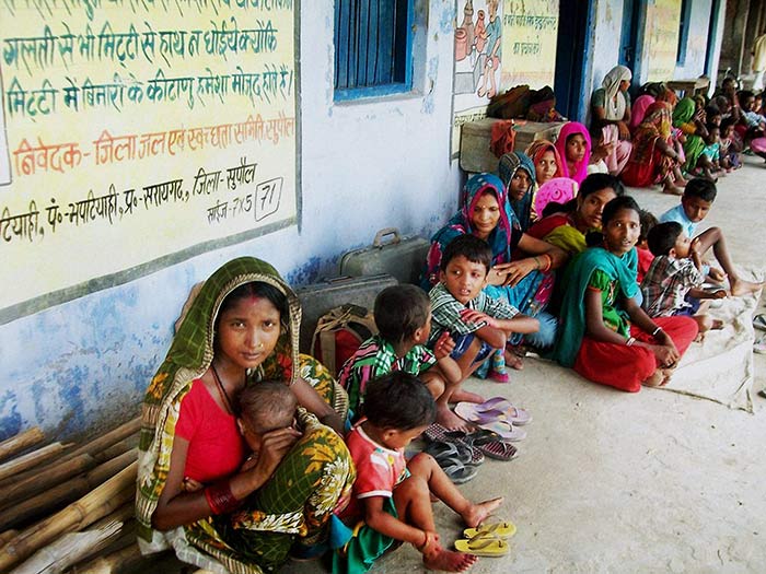 Villagers staying in a government school due to danger to Kosis embankments after heavy flow of water into the river from Nepals side in Supaul, Bihar on Sunday.