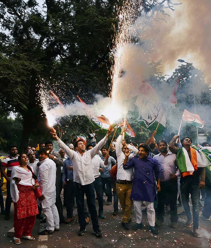 Supporters of the Congress, one of Nitish Kumar's allies in the Mahagathbandhan, celebrate in Delhi.