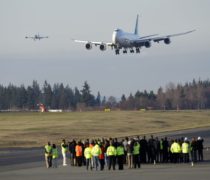 Hundreds of employees and other airplane fans gathered to watch the plane take to the air.(AP Image)