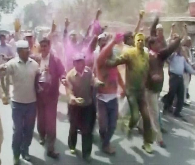 Congress party workers celebrate with colours in Haldwani.