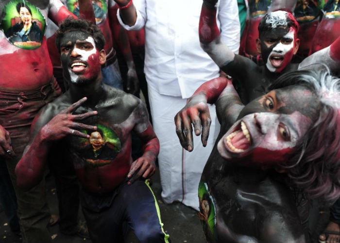 AIADMK supporters painted their bodies as they dance in front of Jayalalithaa's residence.