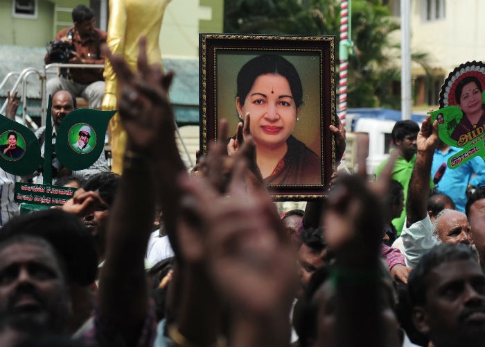 AIADMK supporters carry placards with the image of Jayalalithaa as they celebrate in front of her residence in Chennai on May 19.