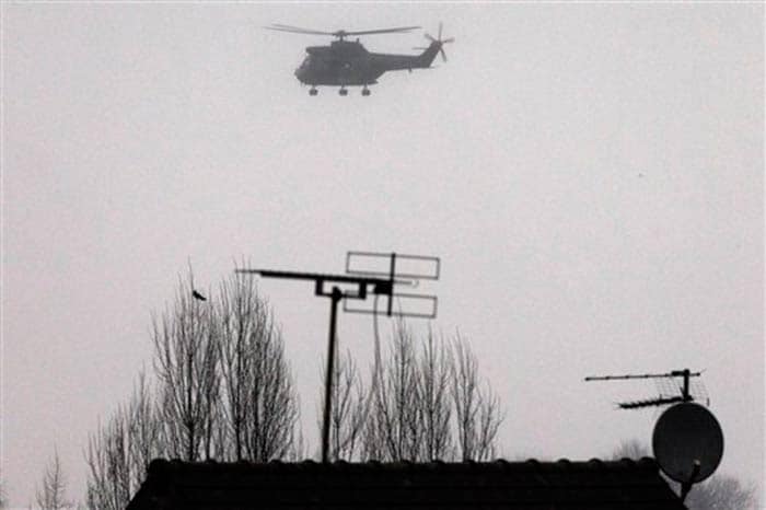 Armed securtiy forces fly overhead in a military helicopter in Dammartin-en-Goele, northeast of Paris on Friday.