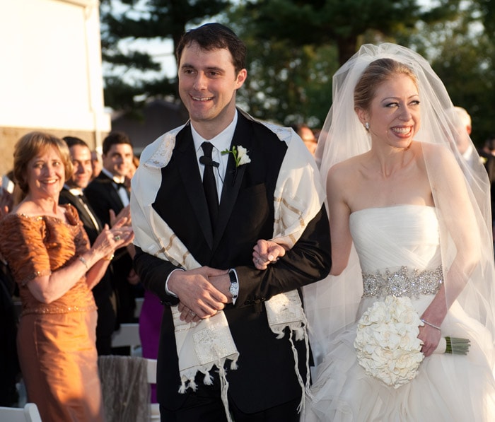 In one of the most awaited and most guarded weddings of the century, Chelsea Clinton wed long time beau Marc Mezvinsky at Hudson Valley estate in the Rhinebeck village of New York.<br><br>Hundreds of guests gathered at the historic estate near the end of a near-perfect summer day of warm temperatures, blue skies and cottony clouds. The ceremony was conducted by a rabbi and a reverend as Chelsea Clinton is Methodist and Mezvinsky is Jewish, and included a poem by Leo Marks titled, "The Life That I Have," according to the family.<br><br>The wedding was a mix of high society and high security. The road to Astor Courts was blocked off on Saturday, neighbours received bottles of wine for their troubles and the sky above was declared a no-fly zone by federal aviation officials. Police and security guards fanned out around the usually sleepy town. (AP Photo)