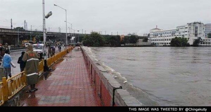 The river Adyar is seen in images flooded almost to the edge of a bridge.