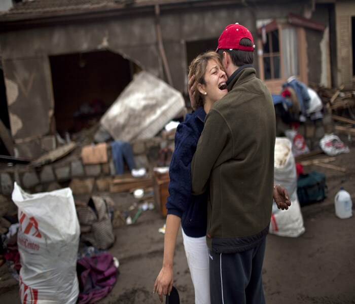 "We have to leave this doomed town," screamed Dennise Pincochet, a resident of Constitucion, in front of her destroyed house and completely devastated neighborhood. (NYT Photo)