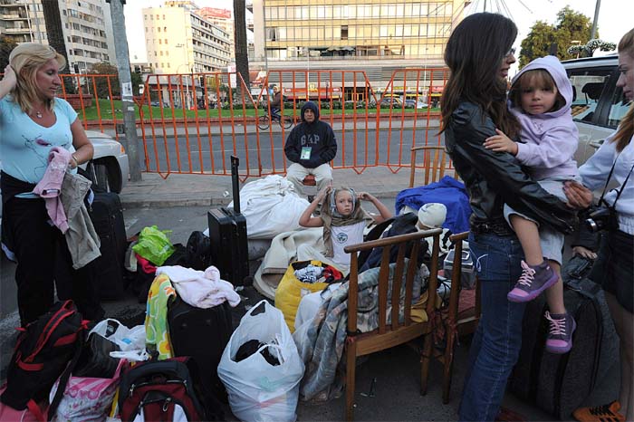 Tourists are seen outside of a destroyed hotel in Vina del Mar after a huge 8.8-magnitude earthquake rocked Chile. (AFP)