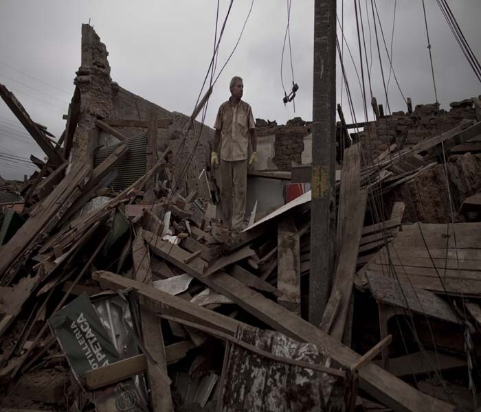 In this picture, a man looks through the remains of his house on in Constitucion.(NYT Photo)