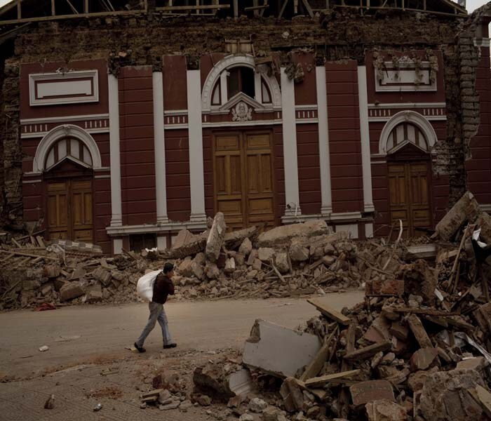 Seen here, a man passing a damaged church on Sunday in Constitucion. (NYT Photo)