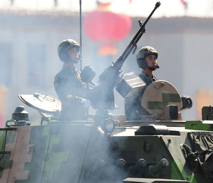 <p>Chinese People's Liberation Army (PLA) tanks rumble pass Tiananmen Square during the National Day parade in Beijing on October 1, 2009. China formally kicked off mass celebrations of 60 years of communist rule with a 60-gun salute that rung out across Beijing's historic Tiananmen Square. AFP PHOTO</p>
<p>&nbsp;<a class="text2bold_link" href="http://www.ndtv.com/convergence/ndtv/new/NDTV-Show-Special.aspx?ID=362">China at 60: Live Blogs</a></p>