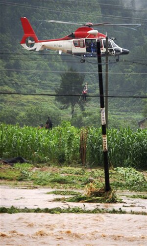 Heavy rains battered parts of southern China for the fifth straight day on Thursday and the country's National Meteorological Centre warned of more stormy weather over the next few days.<br><br>Chinese state television on Thursday showed footage of flooded villages in Guangxi and Fujian provinces, with stranded residents being rescued by emergency workers.<br><br>CCTV also captured a video of a soldier using a rope to winch a baby to safety across a flooded river. Other villagers were rescued by boat from the roof tops of flooded houses. (AP Image)