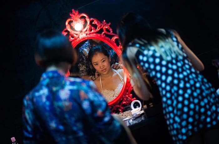 This photo shows Leng Yuting (C), 26, having make up for her underwater photo shoot at studio in Shanghai