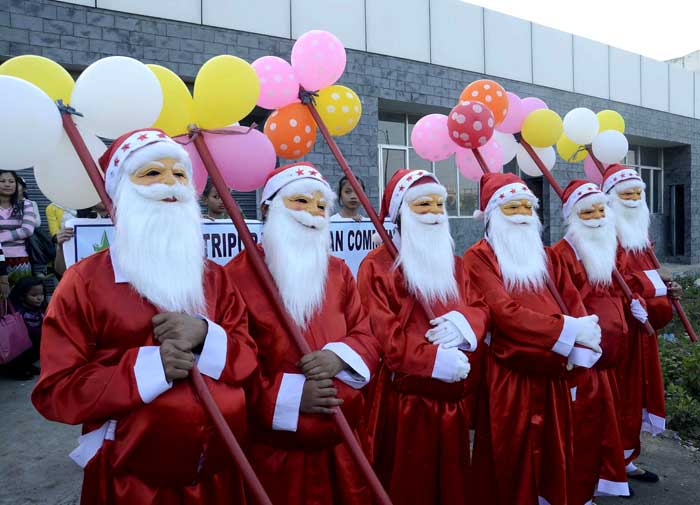 Children dressed up as Santa Claus during Christmas celebrations in Dharmanagar, Tripura. (PTI Photos)