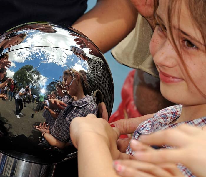 In two decades the issue of climate change has come from the obscurity of science journals to the headlines of major newspapers.<br><br>Several strong interlinkages between climate change and other key environmental problems are likely to be the next-generation-issue.<br><br>Here in this picture, schoolgirls (R) gather around "The People's Orb" (L), a shimmering 20cm silver sphere containing a 350 gigabyte mosaic of stories, voices, images and action collected from around the world to inspire action on climate change in Copenhagen.<br><br>The People's Orb will travel to Denmark to be presented to a representative of world leaders during a dedicated Earth Hour Copenhagen when the lights of the city will be turned off for one hour from 7pm on December 16. (AFP photo)