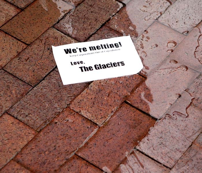 So-called "melting glacier water" was poured on the ground by activists as they protest in front of the headquarters of the American Petroleum Institute during a demonstration against corporations to participate in the upcoming Copenhagen Climate Conference.<br><br>Mobilization for Climate Justice organized the march to call on solutions for climate change and to keep corporations out of the climate conference. (AFP image)