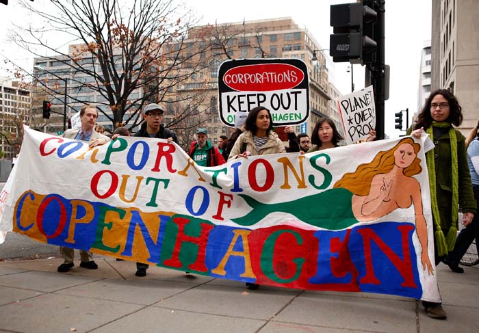Activists protest during a march against corporations to participate in the upcoming Copenhagen Climate Conference. (AFP photo)