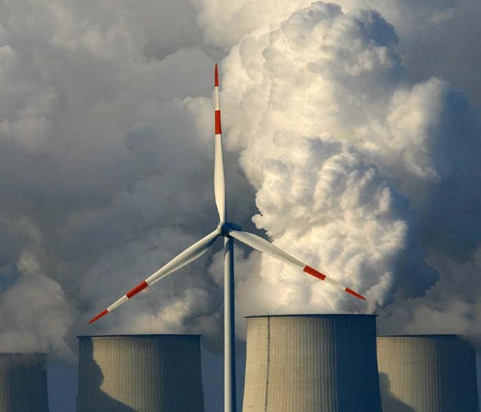 A wind turbine can be seen in front of the lignite-fired power plant in Jaenschwalde, eastern Germany.<br><br>The German cabinet had on December 5, 2007 agreed to a package of measures designed to fight climate change, that it said was one of the most ambitious initiatives of its kind undertaken anywhere in the world. One of the key measures will see renewable energy contribute between 25 and 30 percent of the country's energy needs compared to the current level of 12 per cent. (AFP photo)