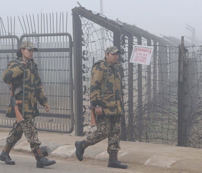 Indian Border Security Force (BSF) women personnel walk through fog as they patrol alongside a barbed wire fence near the India-Pakistan Wagah Border at Attari on January 9.(AFP photo)