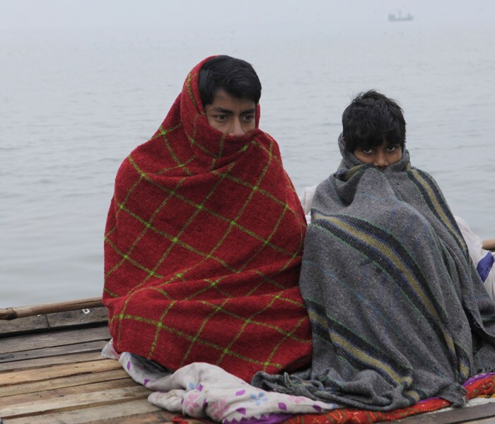 Fog and bone chilling temperatures continue to disrupt normal life in Punjab and Haryana. Severe cold conditions have made it tough for anyone who is outside. Whether you are going to school, office or even shopping, it's just too hard to ignore the chill. (AP Photo)