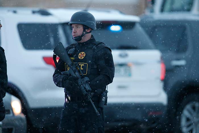 Police stand guard at the intersection of Centennial and Fillmore near a Planned Parenthood clinic Friday, Nov. 27, 2015, in Colorado Springs