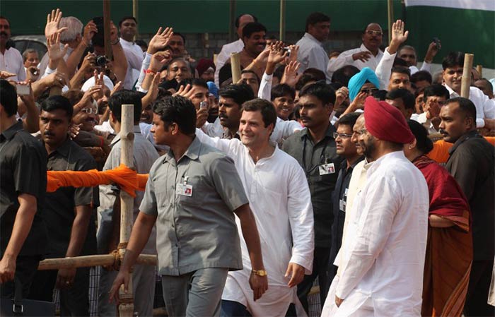 Rahul Gandhi waves towards supporters as he leaves an election rally in Mangolpuri on the outskirts of New Delhi on October 27, 2013.