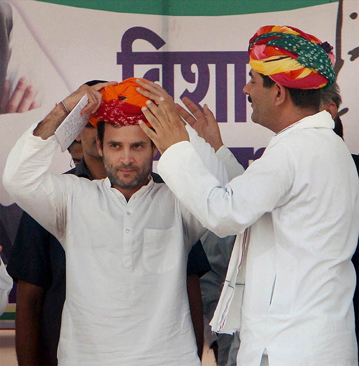 Rahul Gandhi is presented with a traditional turban at a Congress rally in Churu, Rajasthan on October 23, 2013.