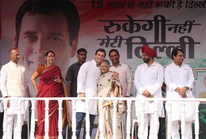 Rahul Gandhi embraces Sheila Dikshit during a Congress rally in Mangolpuri on the outskirts of New Delhi on October 27, 2013.