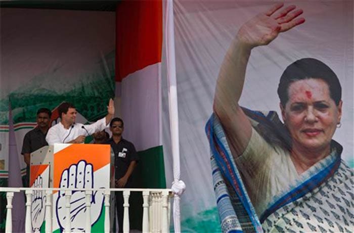 Rahul Gandhi waves to supporters next to a photograph of his mother and Congress party President Sonia Gandhi during a rally in New Delhi, India on October 27, 2013.