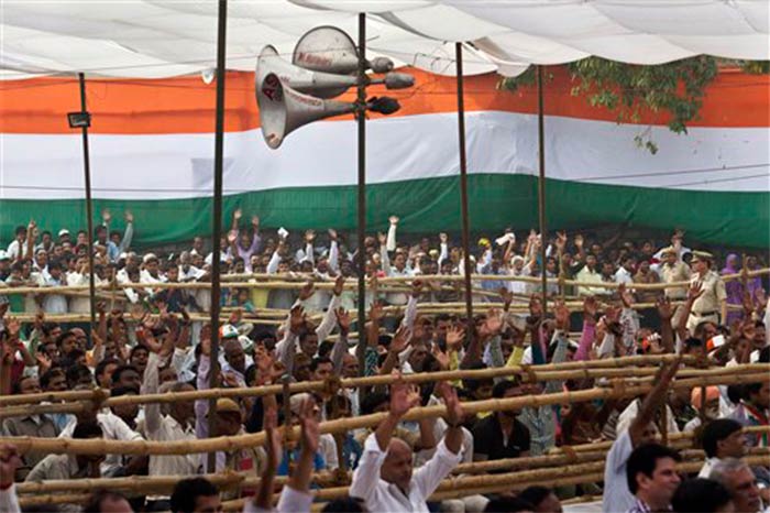 Supporters raise their hands during a Congress rally addressed by Rahul Gandhi in New Delhi on October 27, 2013.