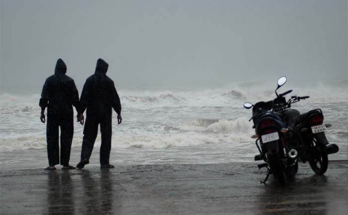 Two men watch the high tide at Gopalpur beach, about 190 kilometers south from Bhubaneswar, Odisha.