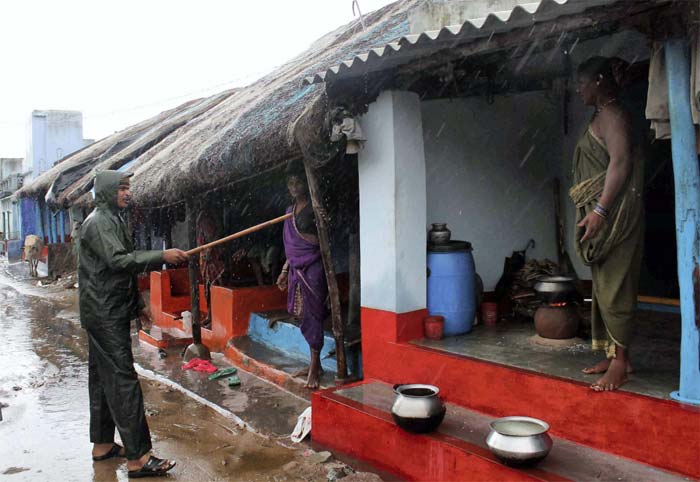 Golabandha: Policemen evacuate fishermen community villagers in Odisha ahead of Cyclone Phailin.