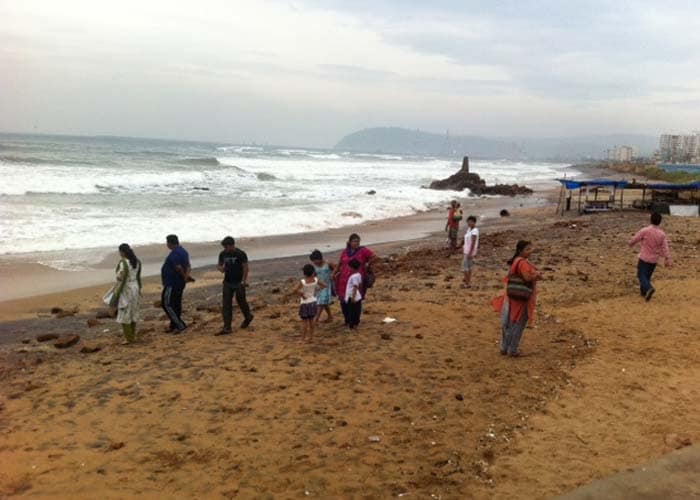 The cyclone has prompted the country's biggest evacuation in 23 years with more than eight lakh people moved up from the coastline in Odisha and Andhra Pradesh to safer places. While Odisha has reportedly evacuated over 7.2 lakh people, Andhra Pradesh has moved about a lakh to safety. Seen here, people arrive at a beach in Visakhapatnam.<br> Photo courtesy: Maya Sharma