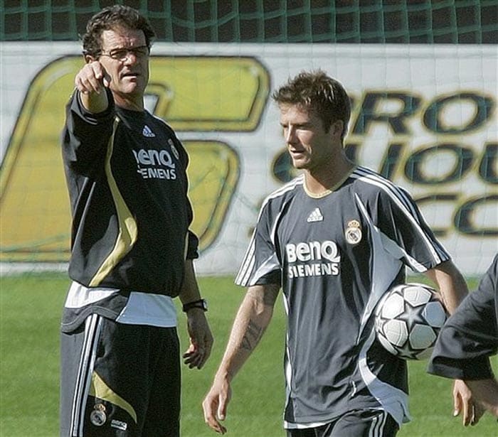 Beckham tearfully relinquished the England captaincy after the 2006 tournament, when England reached the quarterfinals for the second straight time. He was then dropped by Coach Steve McClaren, but was restored as England's qualifying campaign for the 2008 European Championship faltered. McClaren was fired in November 2008 after England failed to reach Euro 2008. <br><br>Real Madrid's David Beckham, right, walks past the team's then coach Fabio Capello during a training session in Madrid, in this Monday, Oct. 30, 2006 file photo. (AP Photo)
