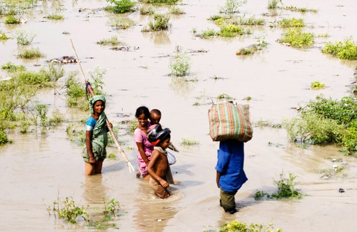 <p><strong>In search of a shelter:</strong> People wade through the rising waters of the Yamuna.<br />
<br />
Attempts are on to evacuate those living on the banks of the swollen river. Incessant rain over the last few days has flooded the region.<br />
<br />
To make things worse, a neighbouring state has released over six lakh cusecs of water in the last couple of days. <em>(AFP)</em></p>