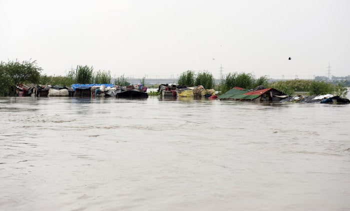 <p><strong>Flooded:</strong> The roofs of huts submerged by the swollen Yamuna are seen protruding from water. Over 300 people have been affected, most of them farmers, living in scattered settlements.<br />
<br />
The Yamuna breached its banks on Friday night, marooning several families.<br />
<br />
The Delhi government has pressed 11 boats and 15 divers for rescue work, and so far rescuers have shifted nearly 150 houses. <em>(AFP)</em></p>