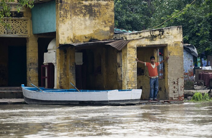 <p><strong>Nowhere to go:</strong> A youth stands in his house as he watches the rising waters of the river Yamuna. Makeshift tents have been put in six places to accommodate the displaced. But many still wait for the rescue teams.<br />
<br />
Flooding of low-lying areas along the Yamuna is almost an annual feature, which means a tough time for the people. <em>(AFP)</em></p>