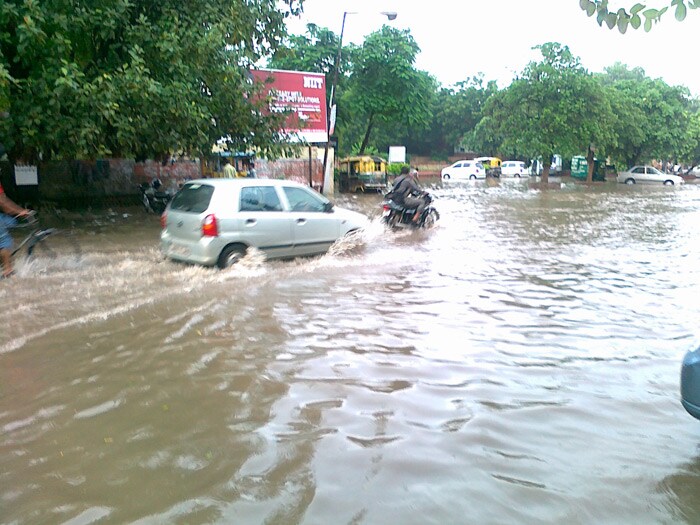 In this picture, a car struggles through the water logged roads. (Photo Courtesy: Ajay Kr Luthra)<br><br><b>Be an I-Witness</b><br><br>You too can share your story through photos and videos. Just upload them here and we'll feature the best entries on Ndtv.com.<br><br><iframe  src="http://www.ndtv.com/convergence/ndtv/new/iframe_NDTVShowUpload.aspx?Template=iwitness&ReqEmail=1&ShowCity=1&ReqCity=1&type=a&ShowDisclaimer=0"  width="400" height="200"  scrolling="no" frameborder="0"> </iframe>