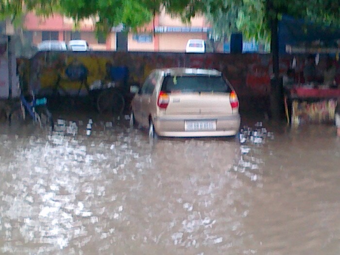 A car parked outside the market with its tyres submerged in the water.(Photo Courtesy: Ajay Kr Luthra)<br><br><b>Be an I-Witness</b><br><br>You too can share your story through photos and videos. Just upload them here and we'll feature the best entries on Ndtv.com.<br><br><iframe  src="http://www.ndtv.com/convergence/ndtv/new/iframe_NDTVShowUpload.aspx?Template=iwitness&ReqEmail=1&ShowCity=1&ReqCity=1&type=a&ShowDisclaimer=0"  width="400" height="200"  scrolling="no" frameborder="0"> </iframe>