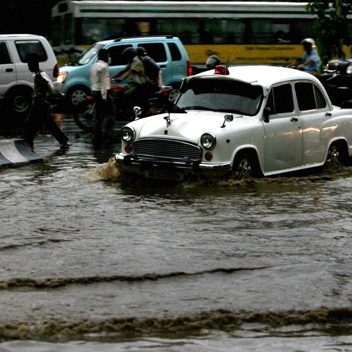 A police vehicle wades through a flooded street on Wednesday evening. The showers started at around 3:30 pm and rain gauges measured 18.5 mm till 8:30 pm. However, the major part of the rains were between 5:30 pm and 8:30 pm when it recorded 17.5 mm. (PTI Photo)