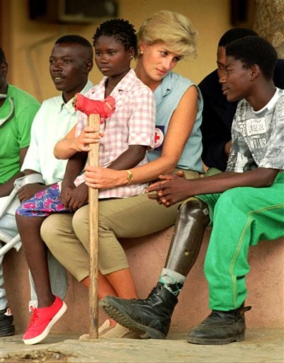 The Other Side: Diana, Princess of Wales, talks to amputees, at the the Neves Bendinha Orthopedic Workshop on the outskirts of Luanda, Angola.