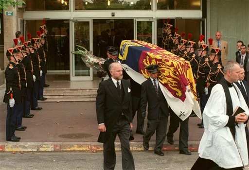 The Last Ride: Republican Guards stand at attention as pall bearers carry the Royal Standard-covered coffin of Diana, Princess of Wales, out of the Salpetriere hospital, Paris.