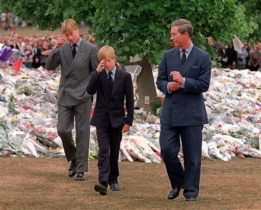 Tears in their eyes: Prince Charles, right, accompanies his sons Prince William, left and Prince Harry after they arrived at Kensington Palace to view tributes left in memory of their mother Princess Diana in London.