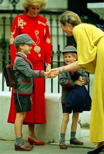 Going to School: Prince William gets a handshake from Frederika Blair-Turner, the headmistress of Wetherby School in Notting Hill, London, as his brother Prince Harry smiles and Princess Diana of Wales, looks on.