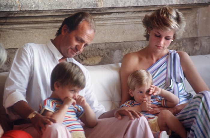 The royalty: King Juan Carlos of Spain and Princess Diana play with Diana's children, Prince William (L) and Prince Harry in August, 1986 in Palma de Mallorca.