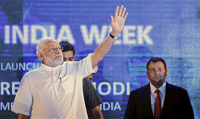 Prime Minister Narendra Modi waves as Cyrus Mistry, chairman of Tata Group watches during the launch of 'Digital India Week' in New Delhi, India, July 1, 2015.